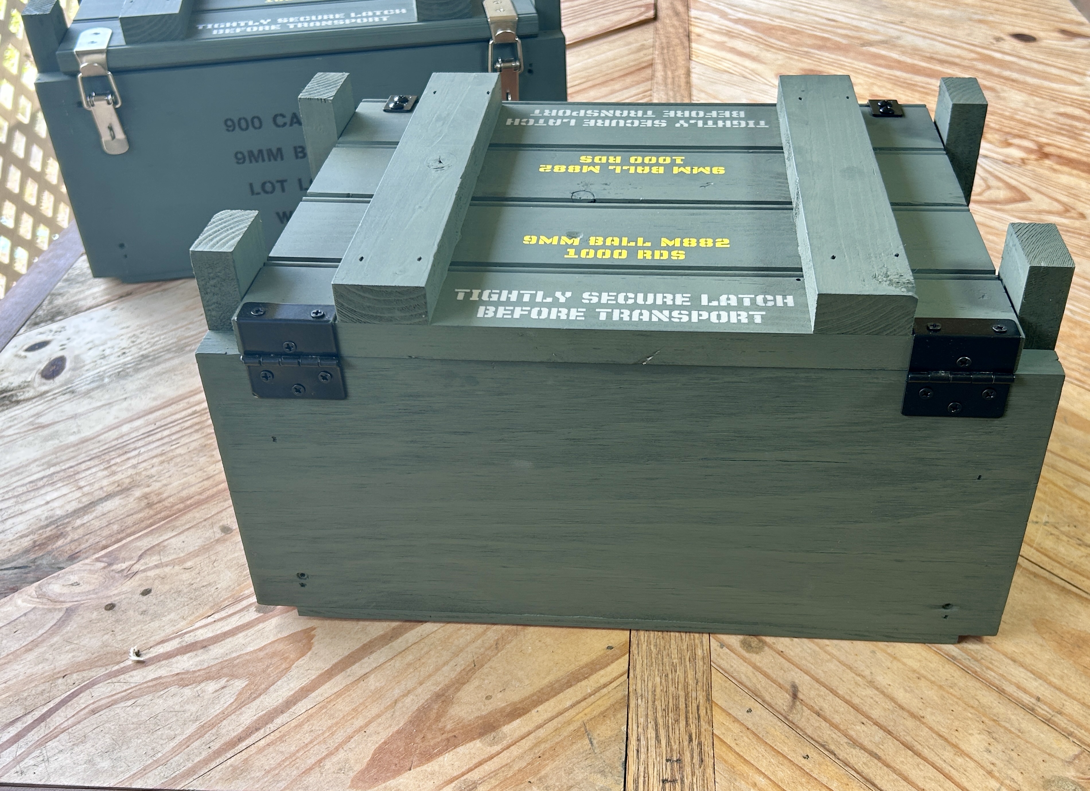 Angled front view of Caliber Collection 9mm crate with black hardware and lid rails