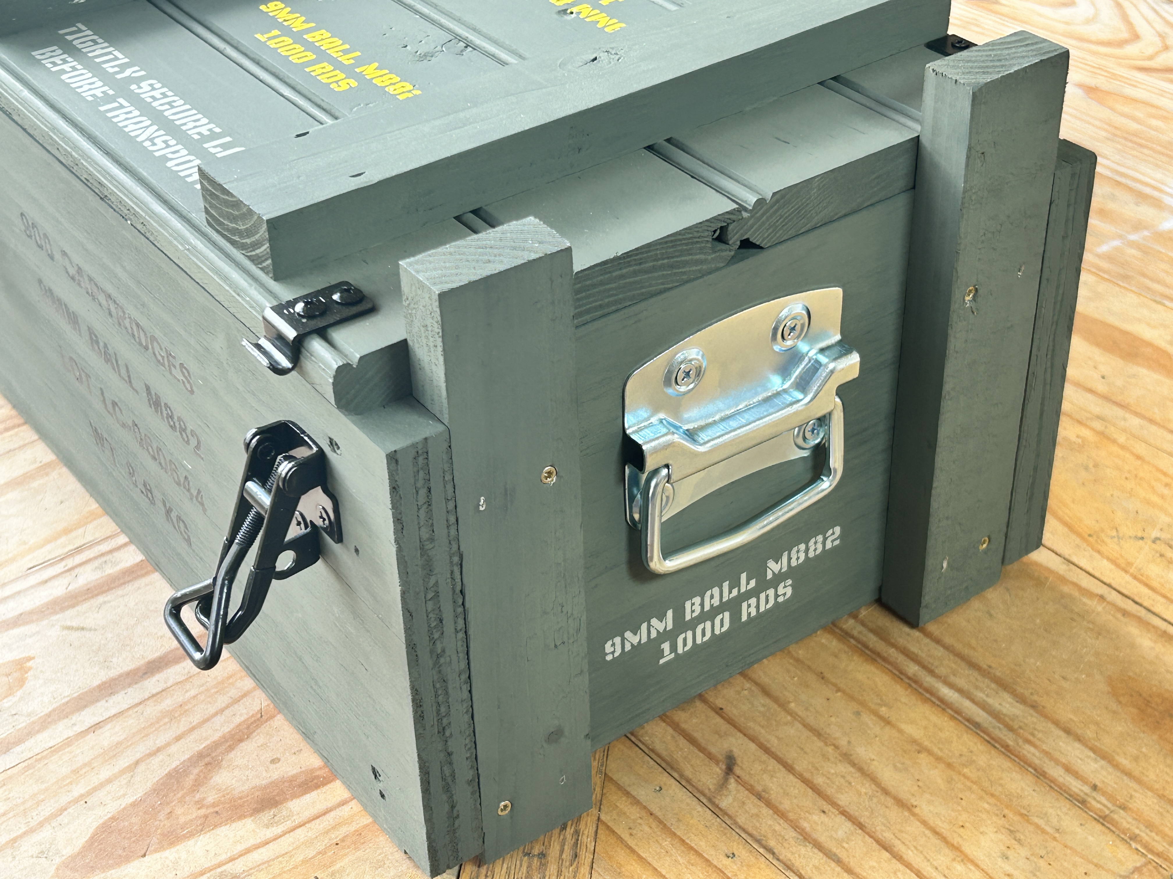 Side view of Caliber Collection crate showing stainless D-ring handle and latch