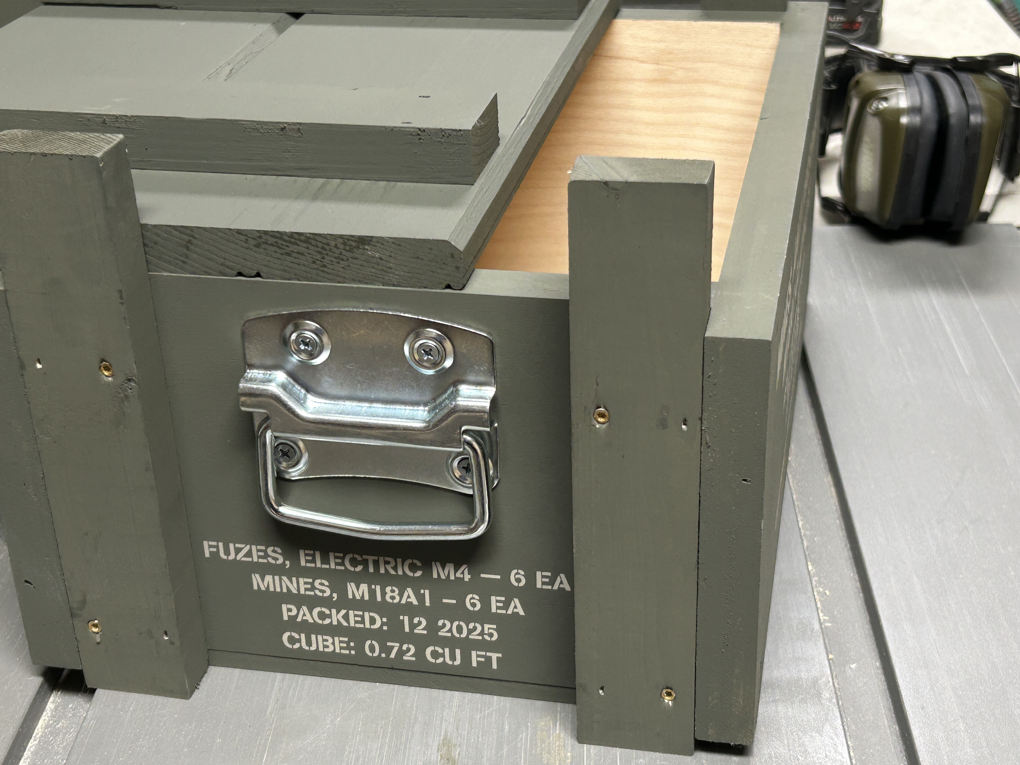 Side stencil and galvanized handle on Claymore Field Crate Standard Edition