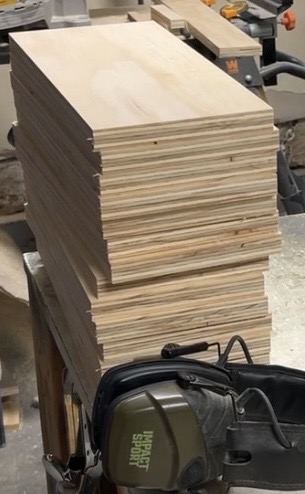Stacked exterior-grade plywood in the Freedom Crate Co. workshop