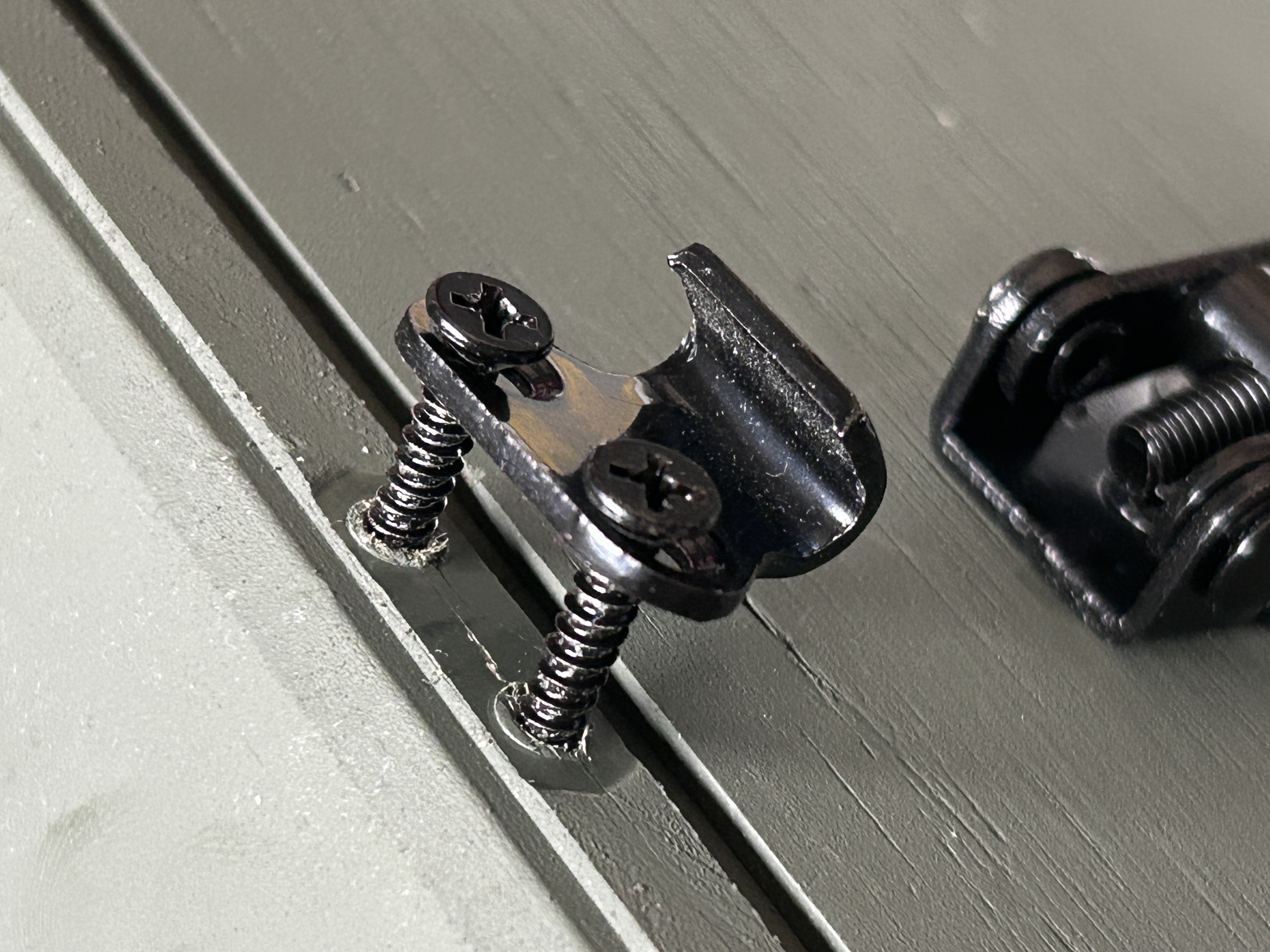 Example of latch catch pulled out of lid after over-tightening