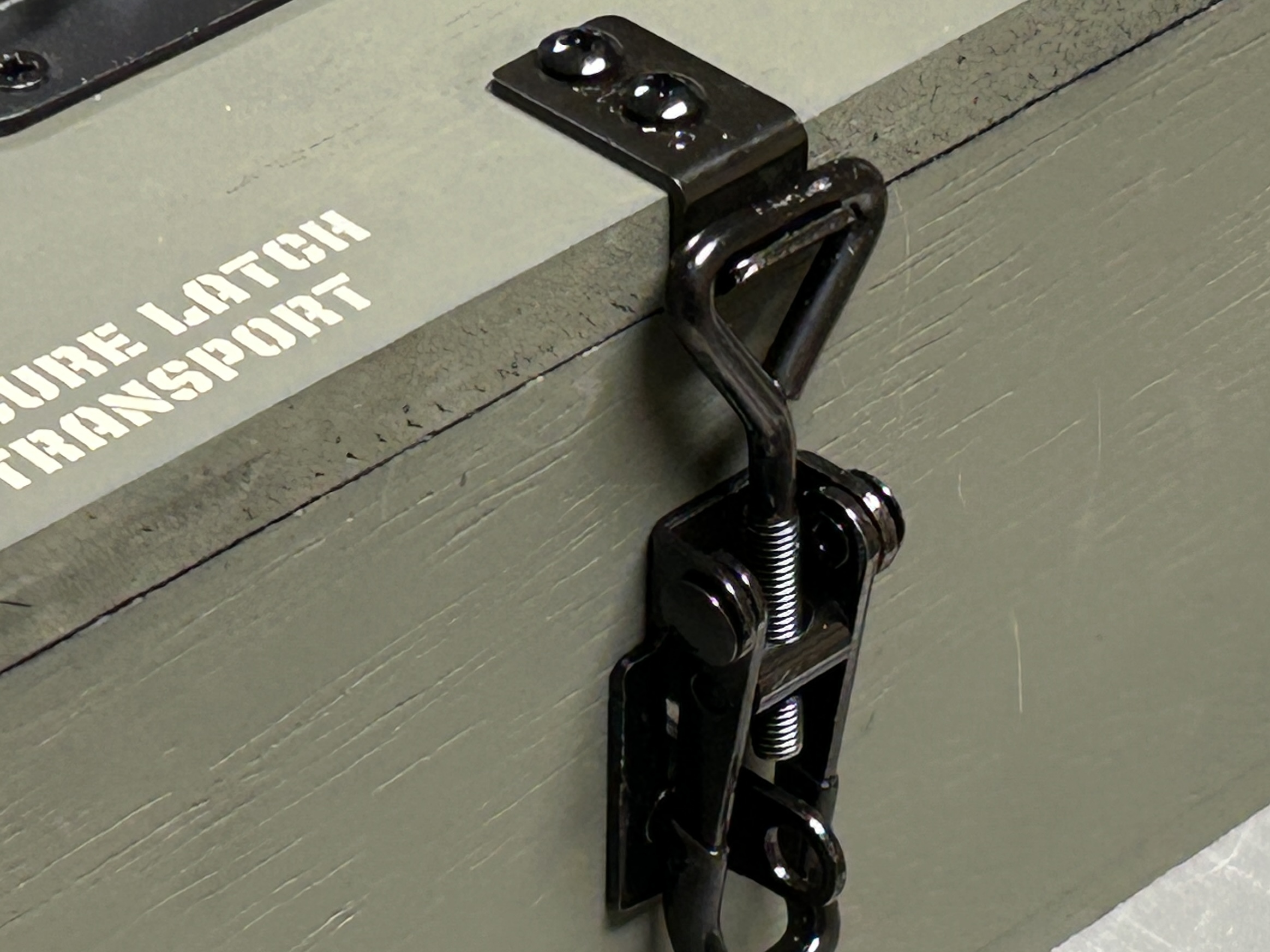 Close-up of edge-mounted toggle latch showing edge-grain screw engagement
