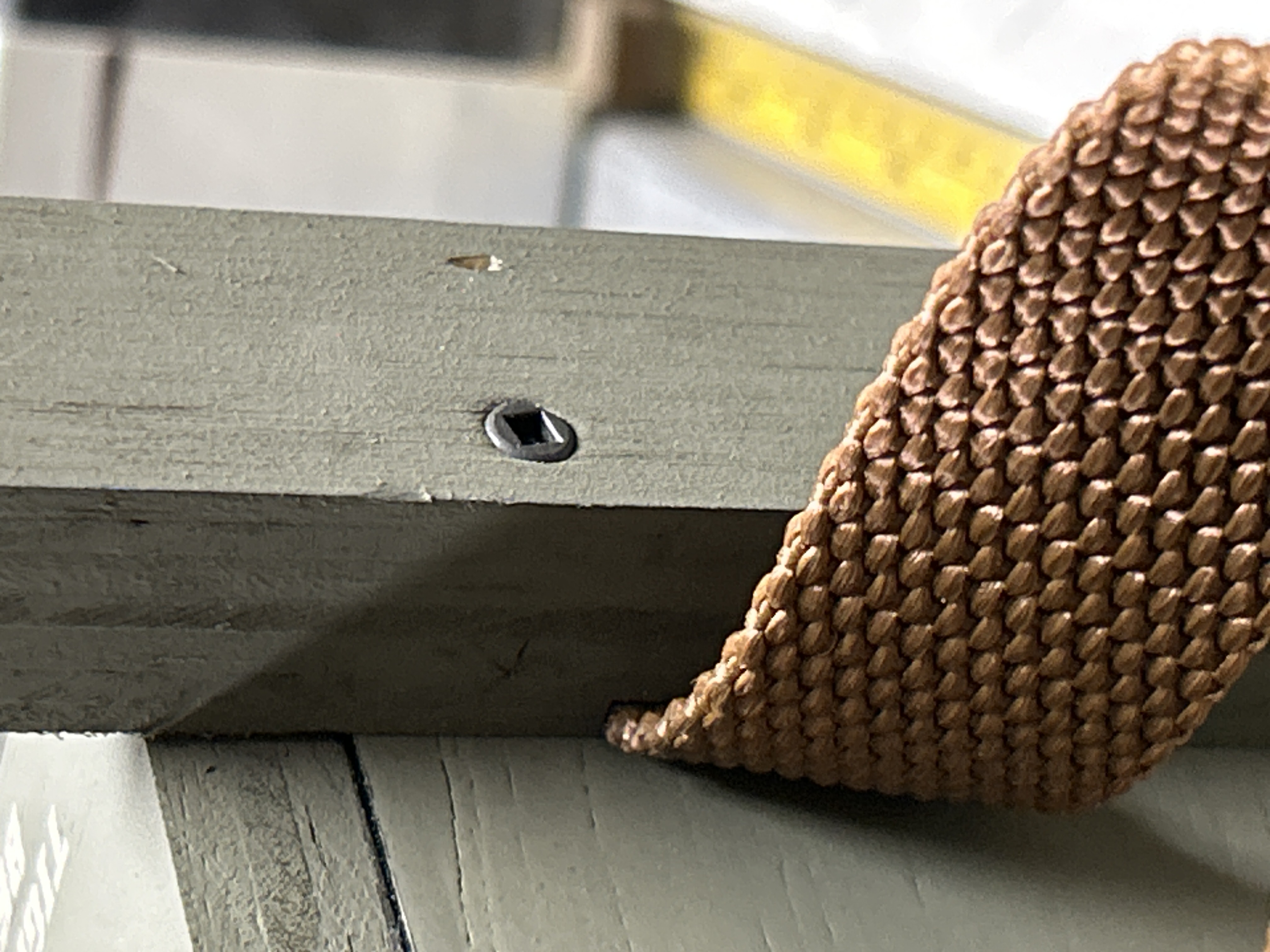 Nylon webbing exiting leg groove with enclosed screw system