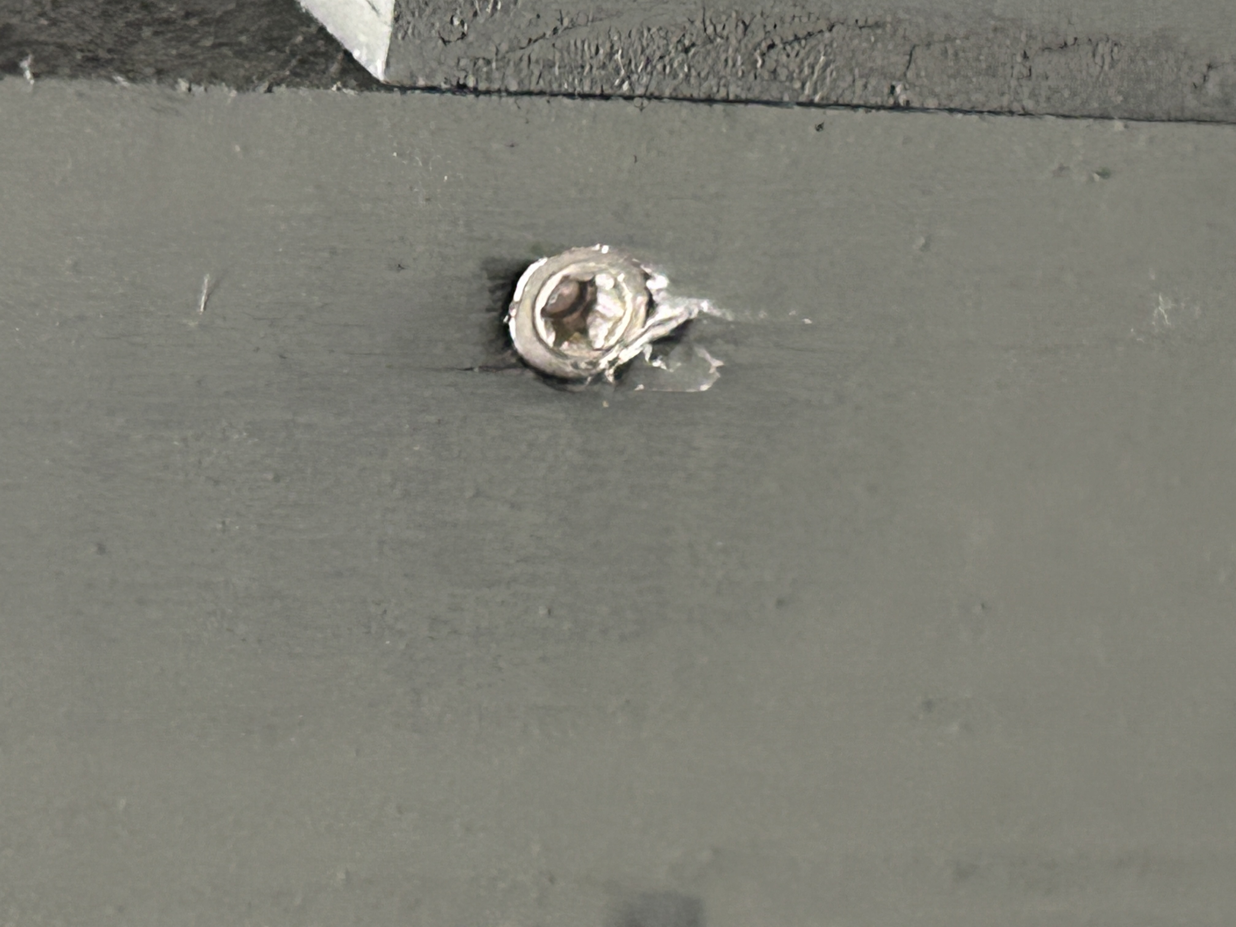 SPAX Power Trim screw being driven into 1x2 pine leg